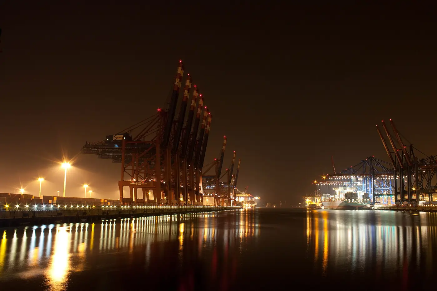 Container terminal cranes and ships at night