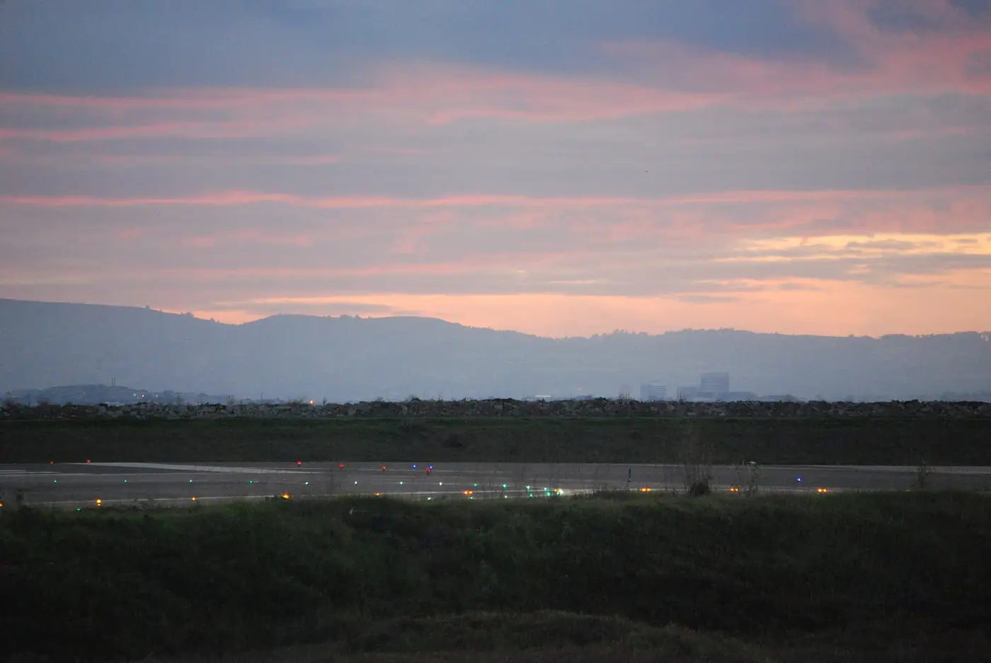 Airport runway lights glowing at dusk